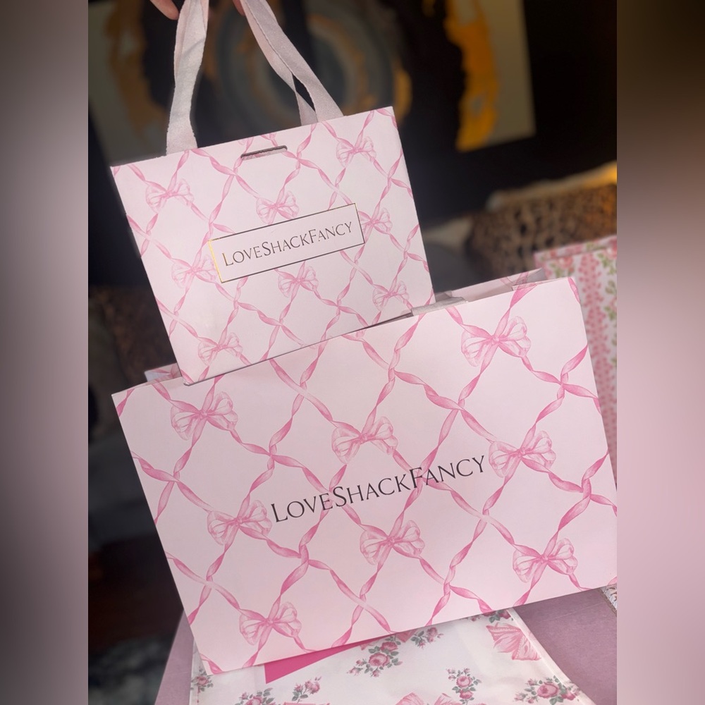 LoveShackFancy pink shopping gift bags with pink ribbon bow pattern